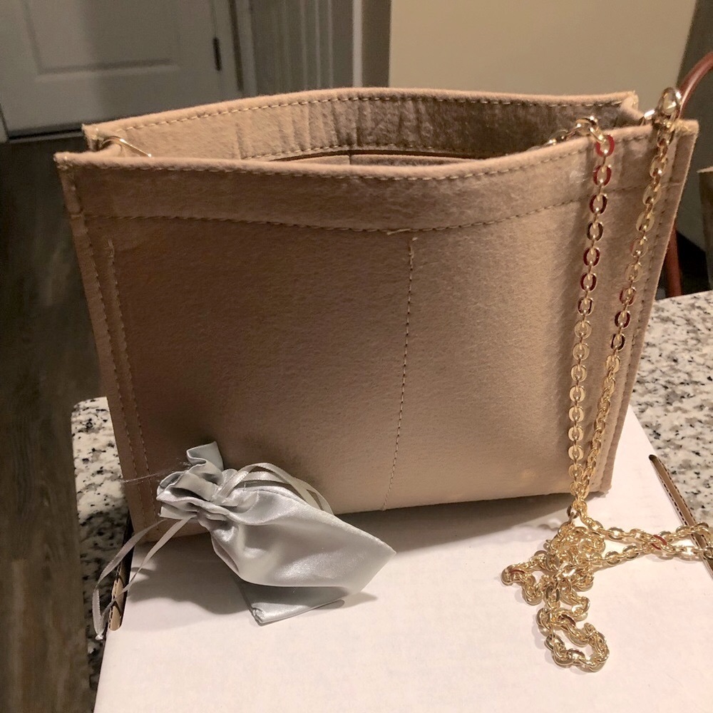 Toiletry 26 Organizer with grommets and chain to transform to a crossbody bag.
